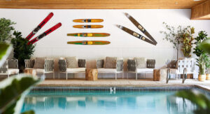 Indoor pool area featuring ski-themed wall art and comfortable seating.