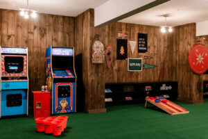 Arcade game area featuring vintage machines, holiday decorations, and a cozy atmosphere.